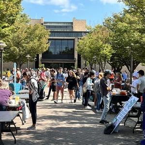 Students walking outside at activities fair